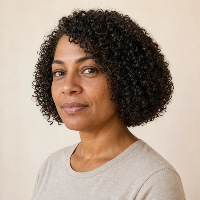 Rounded curly bob on an oval face with natural curls and jaw-level width